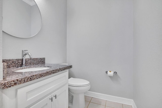 816 Lake Rd, Lake Jackson, TX 77566 - half bathroom featuring toilet, vanity, tile patterned flooring, and baseboards