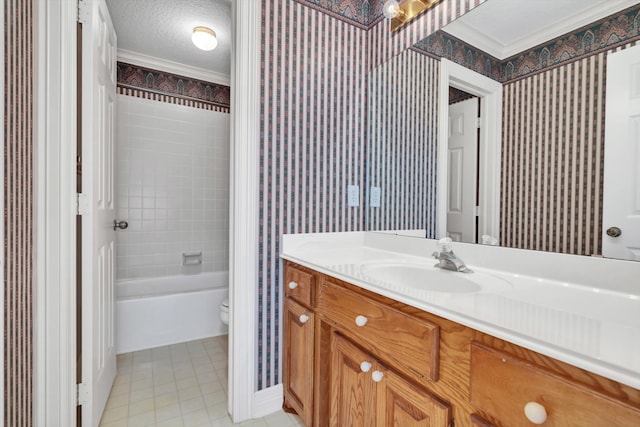 full bathroom featuring a textured ceiling, toilet, vanity, crown molding, and tiled shower / bath combo