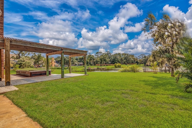 view of yard featuring a patio, a water view, and a pergola