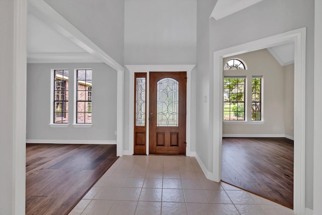 entryway with light hardwood / wood-style flooring, lofted ceiling, and plenty of natural light