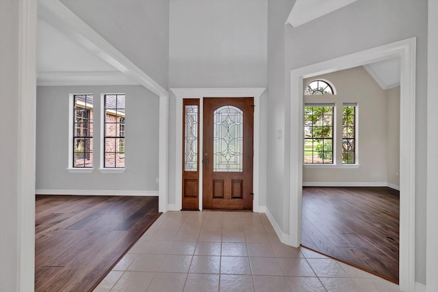 816 Lake Rd, Lake Jackson, TX 77566 - foyer entrance with baseboards, wood finished floors, and high vaulted ceiling