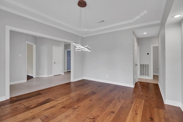 816 Lake Rd, Lake Jackson, TX 77566 - spare room with a tray ceiling, ornamental molding, wood-type flooring, recessed lighting, and baseboards
