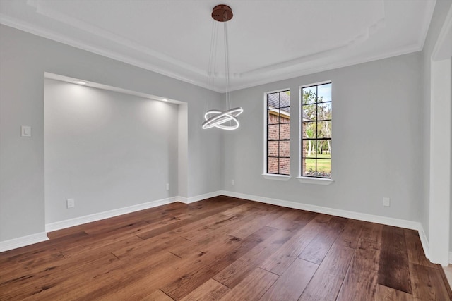 816 Lake Rd, Lake Jackson, TX 77566 - spare room with a chandelier, a tray ceiling, wood-type flooring, crown molding, and baseboards