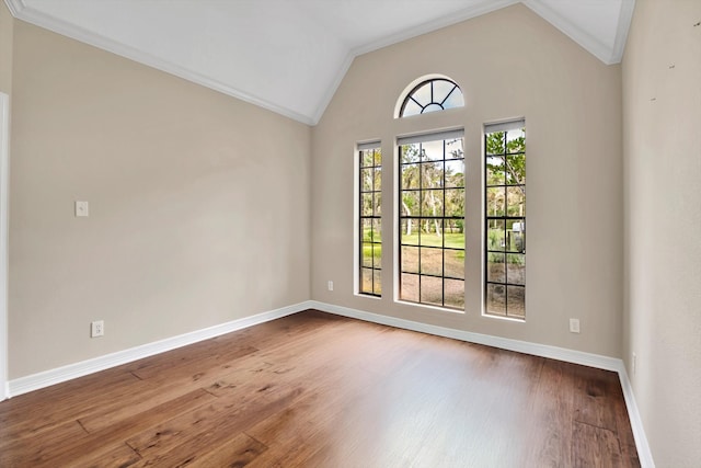 unfurnished room with crown molding, wood-type flooring, and vaulted ceiling