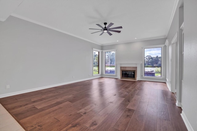 816 Lake Rd, Lake Jackson, TX 77566 - unfurnished living room with dark wood-style floors, a ceiling fan, a glass covered fireplace, baseboards, and ornamental molding