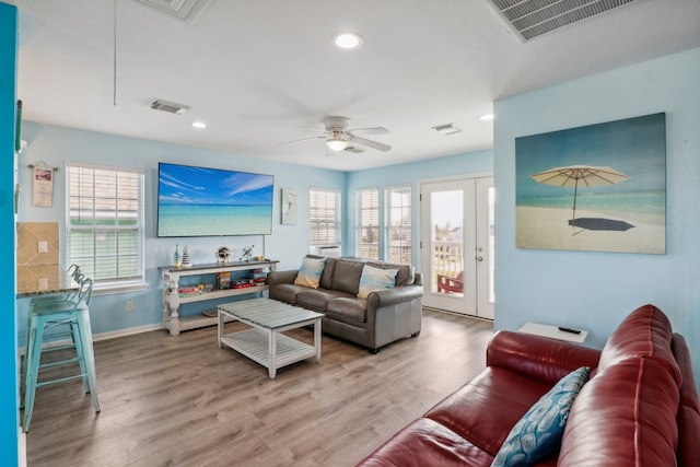 living room featuring french doors, ceiling fan, hardwood / wood-style flooring, and plenty of natural light