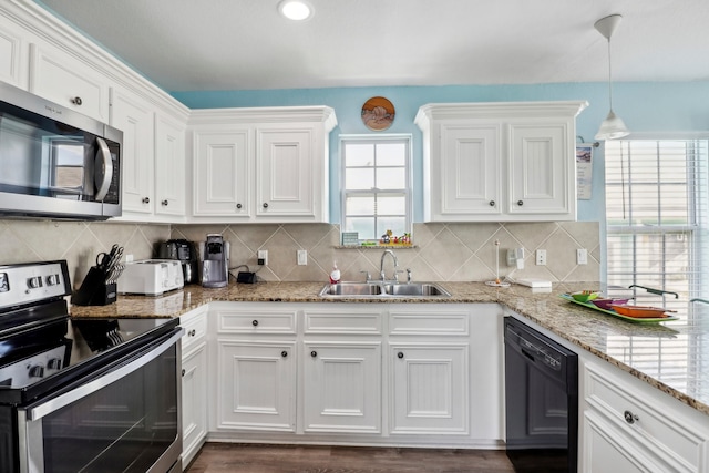 kitchen with stainless steel appliances, hanging light fixtures, dark hardwood / wood-style flooring, and white cabinets