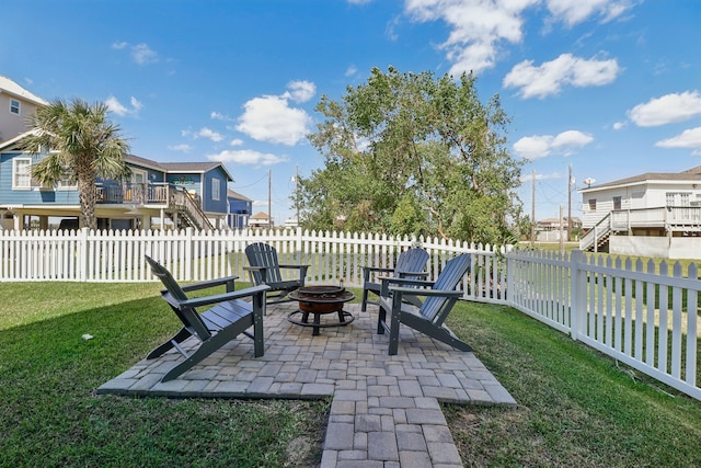 view of patio / terrace with an outdoor fire pit and a deck