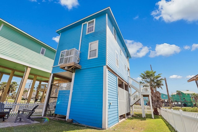 back of property featuring a patio and a lawn