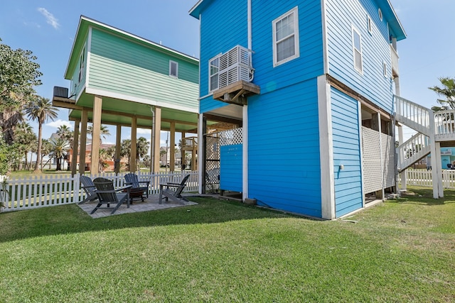 rear view of property featuring a yard and a patio