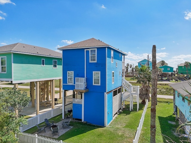 back of property featuring a patio and a lawn