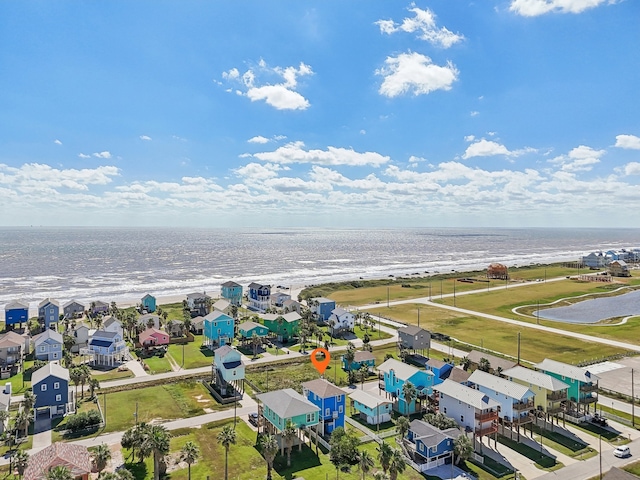 bird's eye view featuring a water view and a beach view