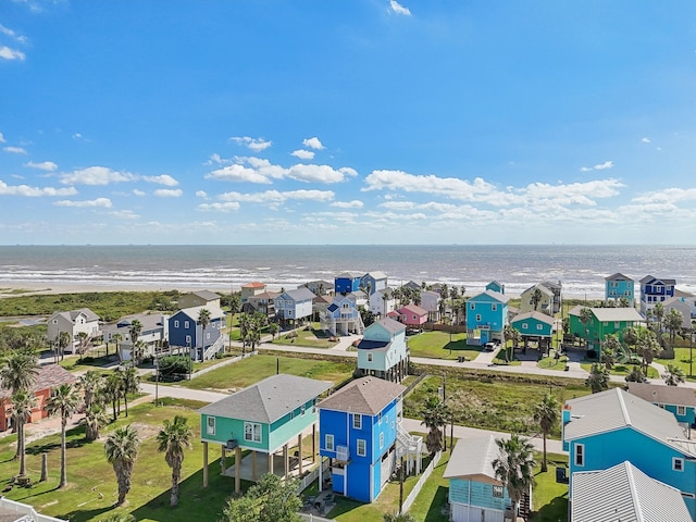 drone / aerial view featuring a water view and a view of the beach