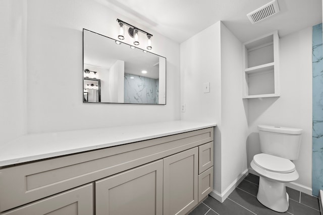 bathroom with vanity, toilet, tile patterned flooring, and a shower