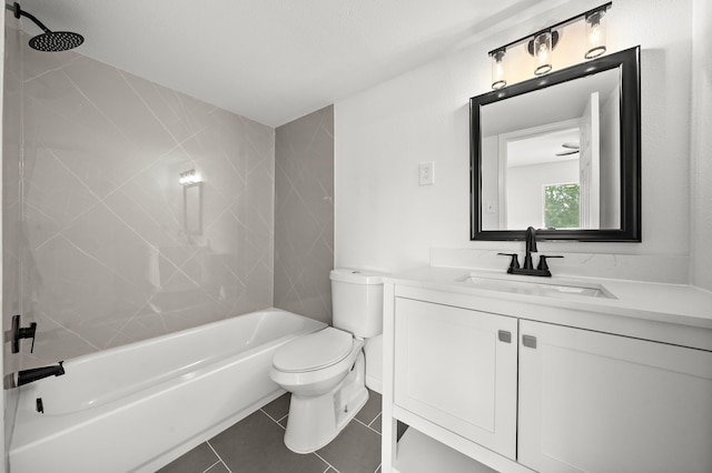 full bathroom featuring tile patterned flooring, vanity, tiled shower / bath combo, and toilet