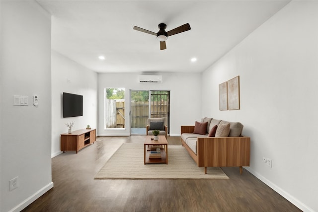 living room with wood-type flooring, a wall mounted air conditioner, and ceiling fan