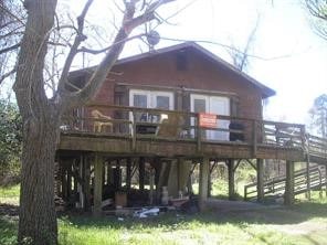 back of house with a deck