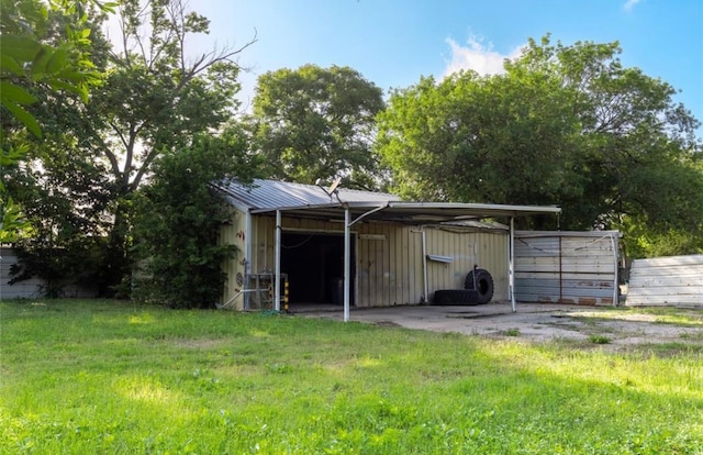 view of outbuilding featuring a lawn