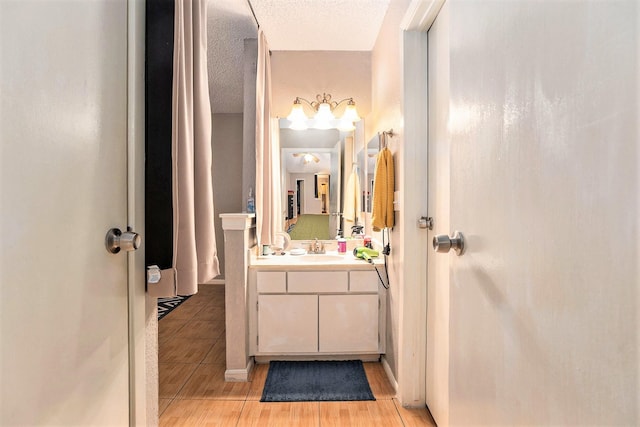 bathroom featuring vanity, a textured ceiling, and hardwood / wood-style flooring