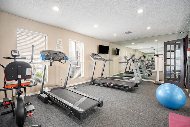 gym with a textured ceiling