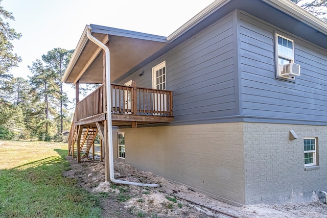 view of home's exterior with a deck and a yard