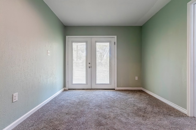 empty room featuring french doors and carpet floors