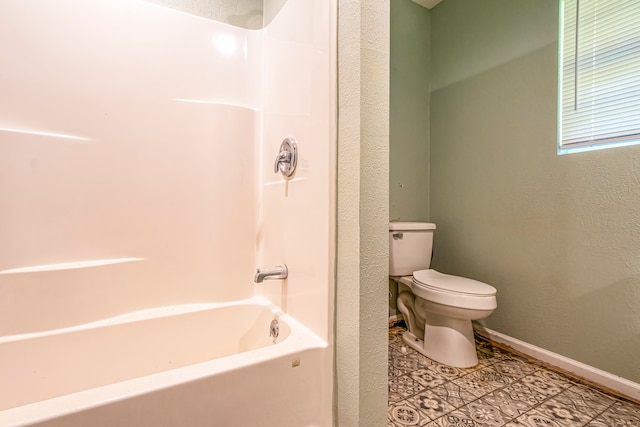 bathroom with shower / bathtub combination, toilet, and tile patterned flooring