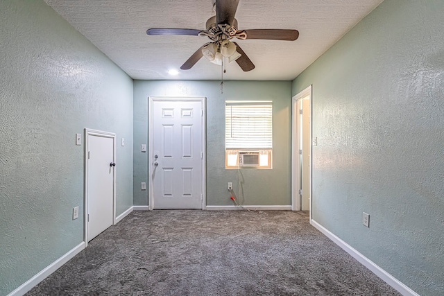 unfurnished room with cooling unit, a textured ceiling, carpet flooring, and ceiling fan