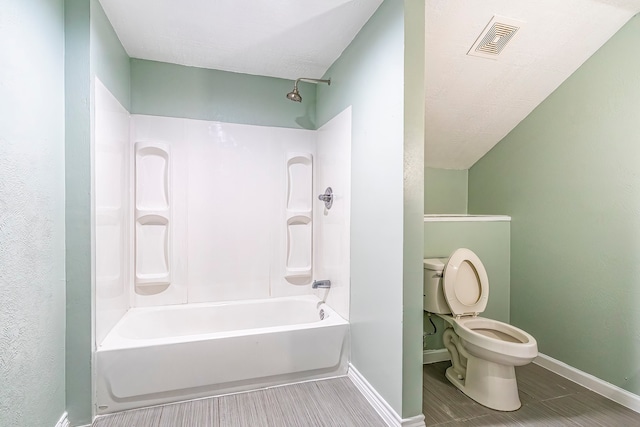 bathroom featuring toilet and shower / bath combination