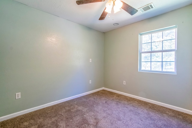 empty room featuring ceiling fan and carpet floors