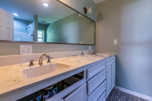 bathroom with vanity and a shower