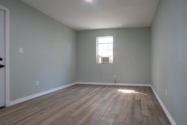 unfurnished room with hardwood / wood-style flooring and cooling unit