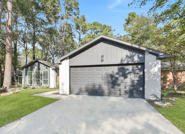 view of front of property featuring a garage and a front lawn