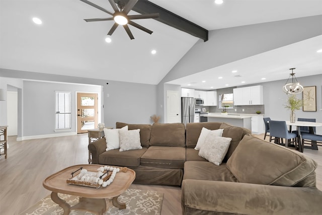 living room with sink, light hardwood / wood-style floors, ceiling fan, beam ceiling, and high vaulted ceiling