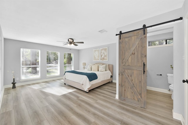 bedroom featuring light hardwood / wood-style floors, multiple windows, and ceiling fan