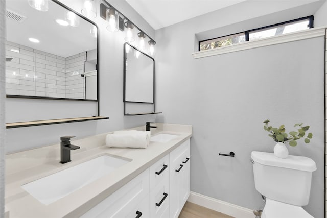 bathroom featuring toilet, hardwood / wood-style floors, vanity, and a tile shower