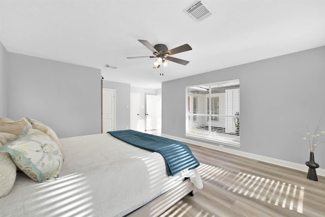 bedroom with ceiling fan and light hardwood / wood-style flooring