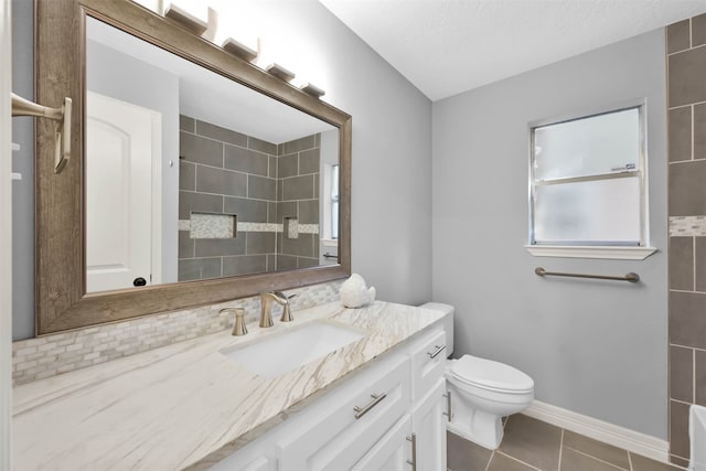 bathroom featuring vanity, toilet, and tile patterned floors