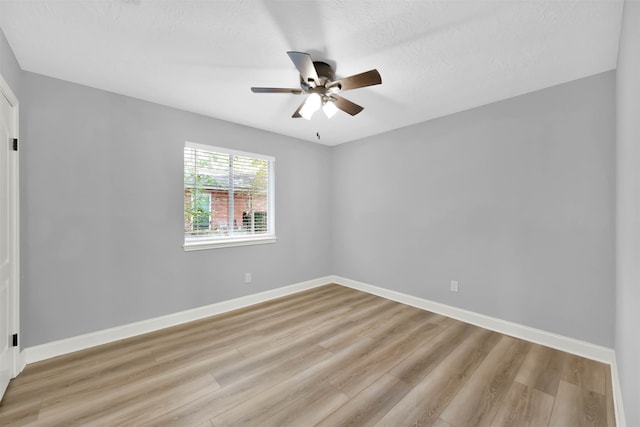 empty room featuring light hardwood / wood-style flooring, a textured ceiling, and ceiling fan