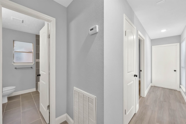 corridor with light wood-type flooring