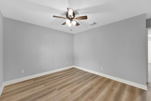 spare room featuring light hardwood / wood-style flooring, a textured ceiling, and ceiling fan