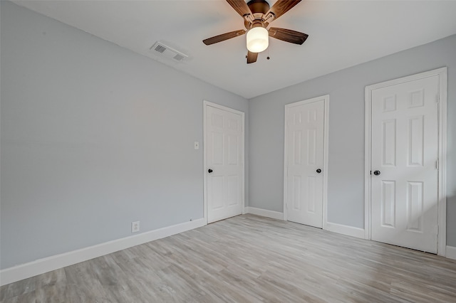 unfurnished bedroom with ceiling fan and light hardwood / wood-style floors