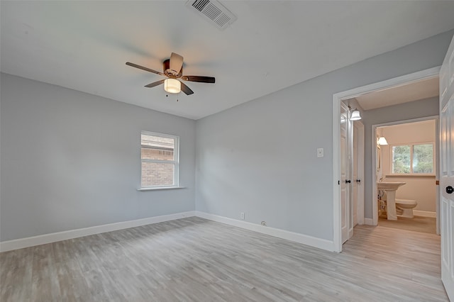 unfurnished room with light hardwood / wood-style flooring, a healthy amount of sunlight, and ceiling fan