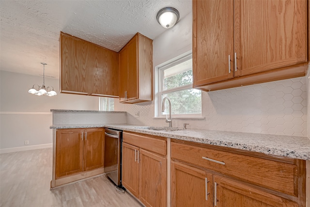 kitchen featuring light hardwood / wood-style flooring, hanging light fixtures, backsplash, sink, and a notable chandelier