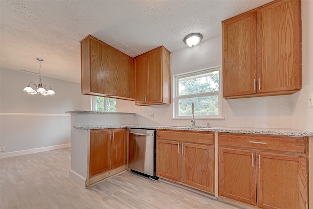 kitchen featuring sink, dishwasher, decorative light fixtures, light hardwood / wood-style flooring, and a chandelier