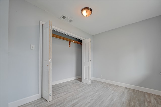 unfurnished bedroom with light hardwood / wood-style floors and a closet