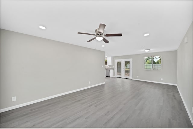 unfurnished living room with french doors, ceiling fan, and hardwood / wood-style floors