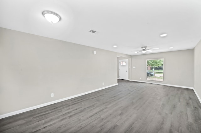 spare room featuring dark hardwood / wood-style floors and ceiling fan