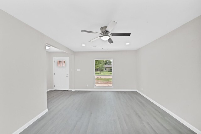 spare room featuring light hardwood / wood-style floors and ceiling fan