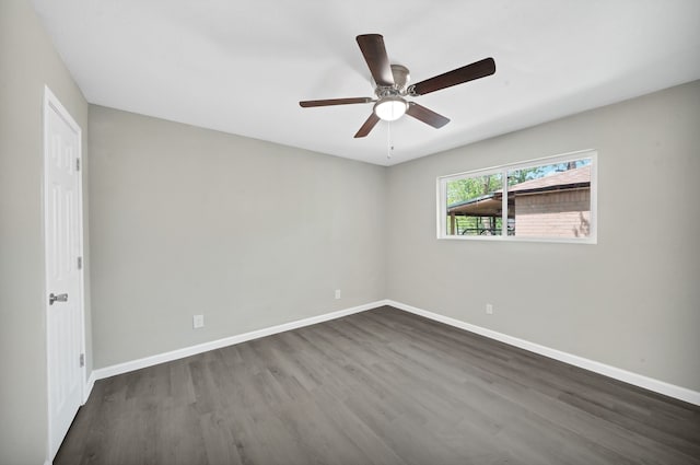 unfurnished room with ceiling fan and dark hardwood / wood-style flooring